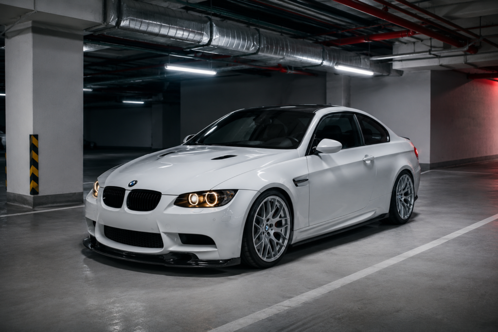 White BMW sports coupe in modern underground parking garage